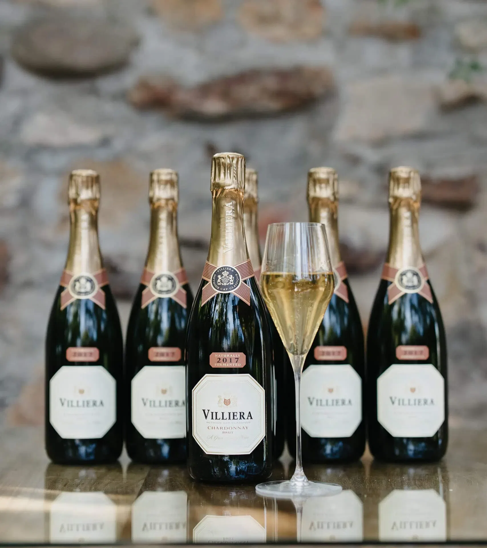 Chilled Villiera Chardonnay Sparkling Wine Bottles With A Filled Glass.