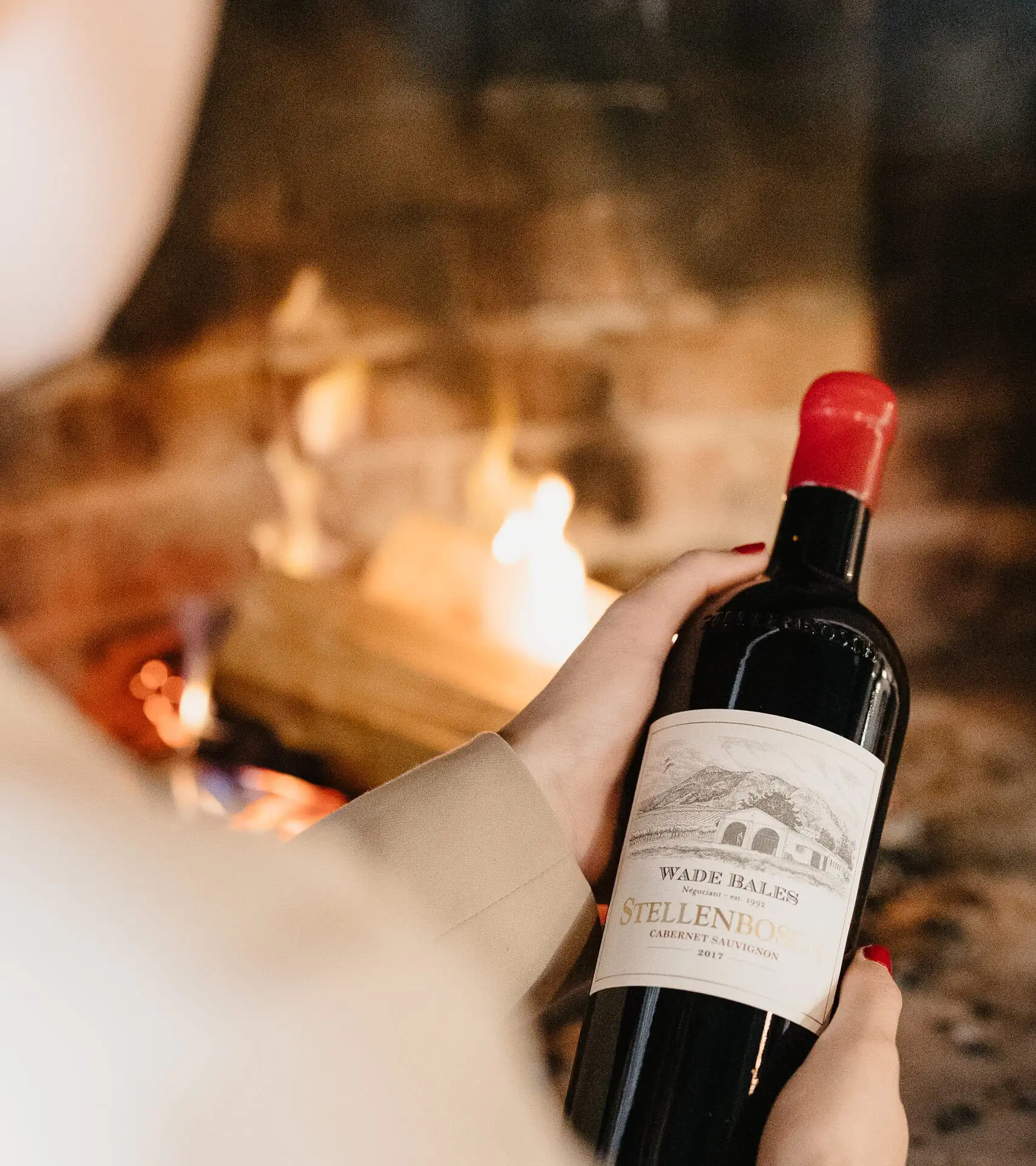 Hand Holding A Bottle Of Stellenbosch Cabernet Sauvignon By Wade Bales.