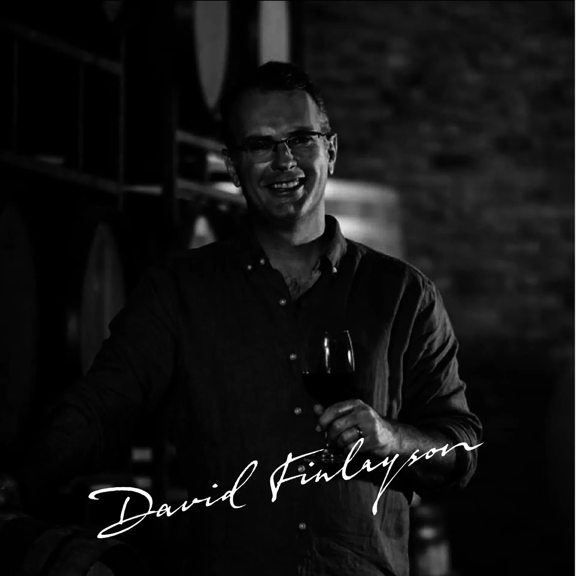 Smiling Winemaker Holding A Glass Of Stellenbosch Wine.