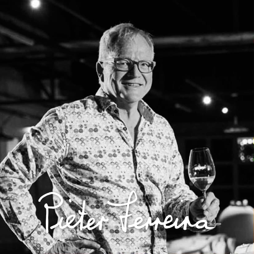 Pieter Ferreira Showcasing A Glass Of Stellenbosch Wine.
