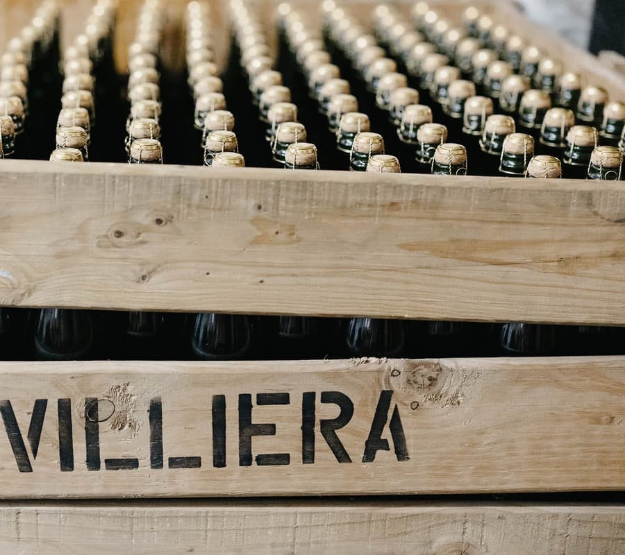 Wooden Crate Displaying Villiera Brut Natural 2021 Wine Bottles, Showcasing Stellenbosch Wine.