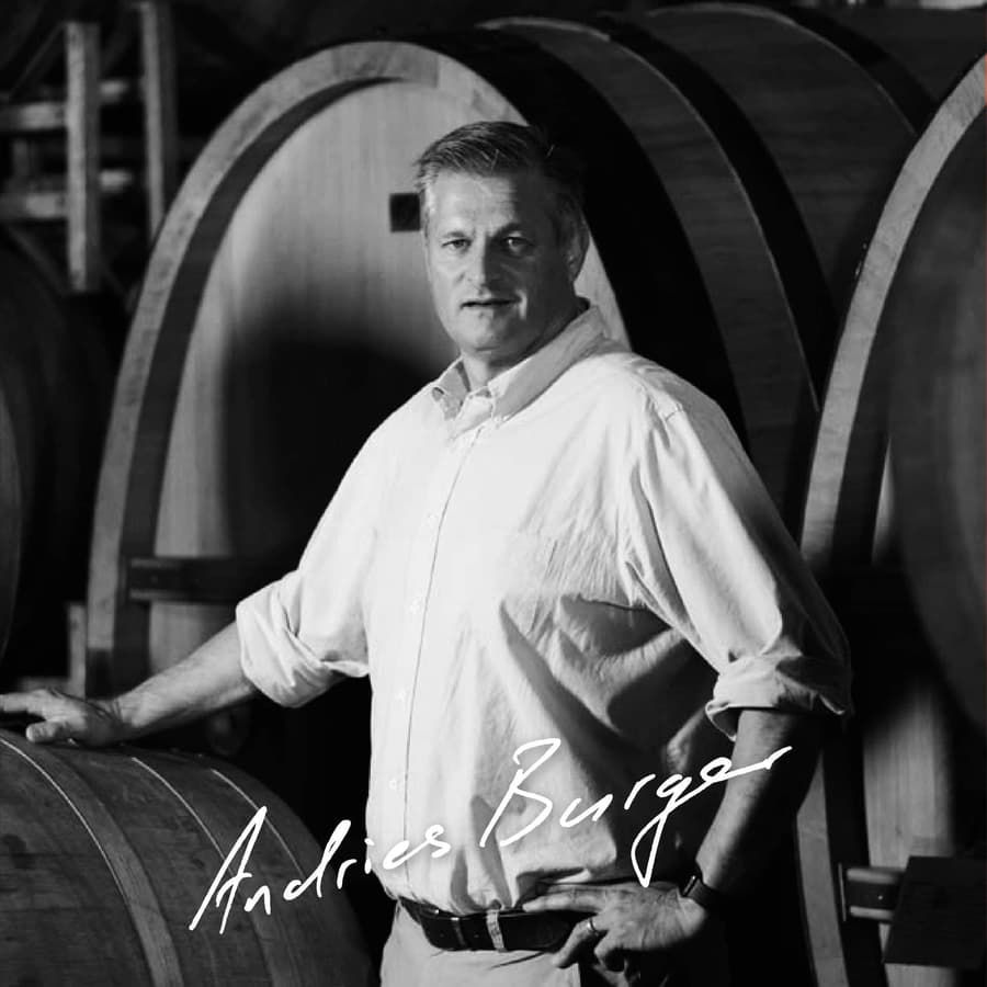 Andries Burger Standing Confidently Among Wine Barrels At Simon Wine Emporium.