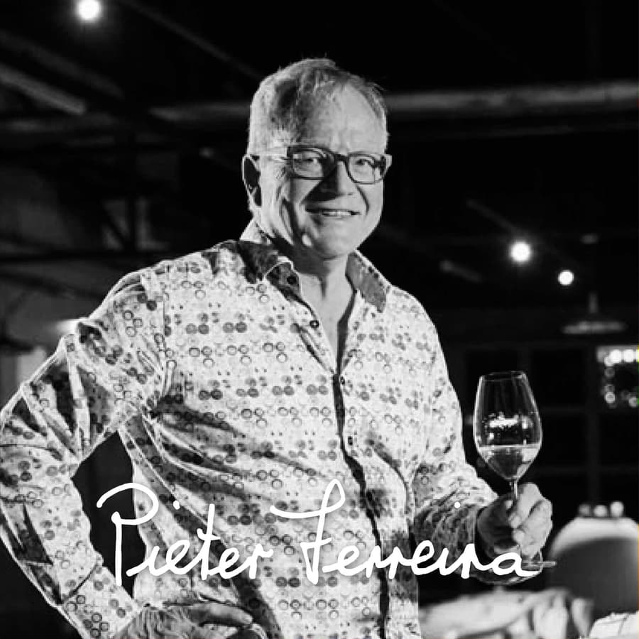 Pieter Ferreira Showcasing A Glass Of Stellenbosch Wine.